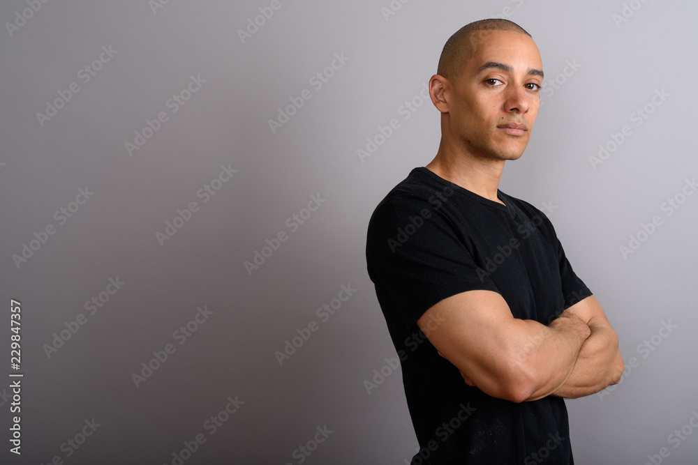 Profile view of handsome bald man with arms crossed Profile view of handsome bald man with arms crossed