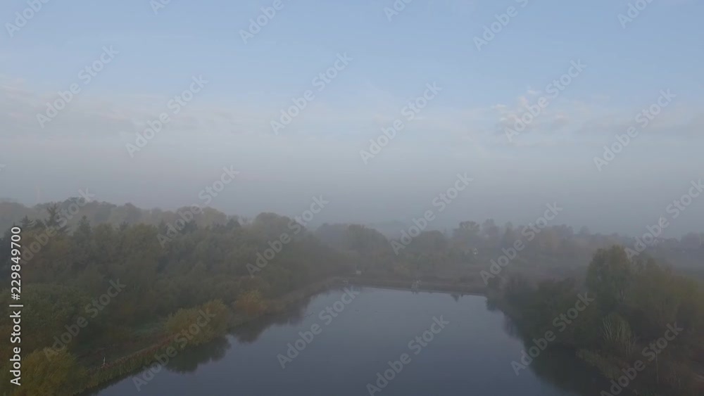 Drone shot a foggy morning in southern Sweden, two birds flying into frame. Sunrise but the sun can not really break the fog. Drone shot a foggy morning in southern Sweden, two birds flying into frame. Sunrise but the sun can not really break the fog.