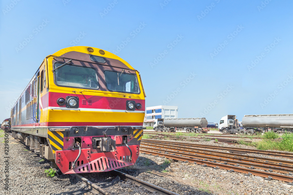Fototapeta premium yellow diesel engine locomotive train on railway station