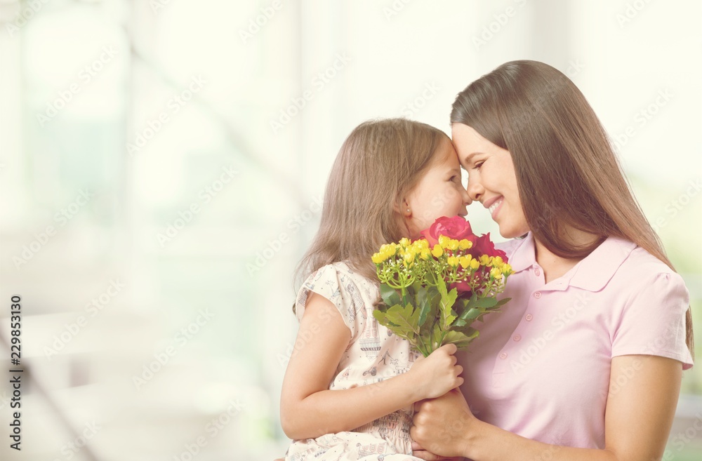 Happy Mother and daughter together with flowers Happy Mother and daughter together with flowers