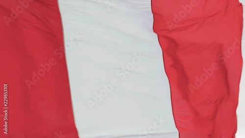 Slow motion footage of the Flag of Peru waving in the wind photo