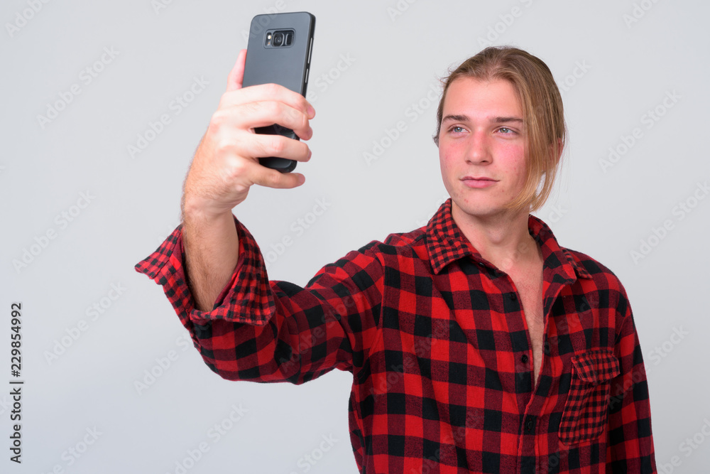 Young handsome hipster man with long blond hair Young handsome hipster man with long blond hair