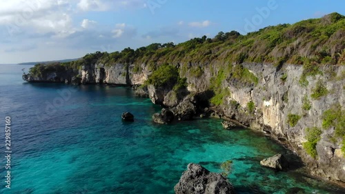 Aerial backward video of Coral Cliff Shoreline with beautiful sea, coral, mangrove forest & sky landscape photo