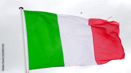 Italian flag fluttering in the wind with a white background photo