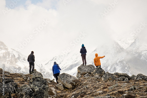 A group of climbers look out over the Khumbu Glacier in the Himalayas photo