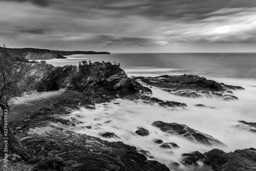 Moody black and white rocky seascape