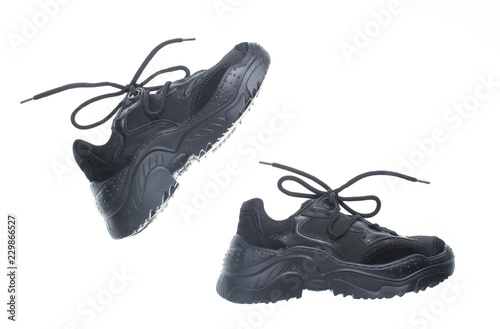 фотографія Black sneakers with laces isolated on white background