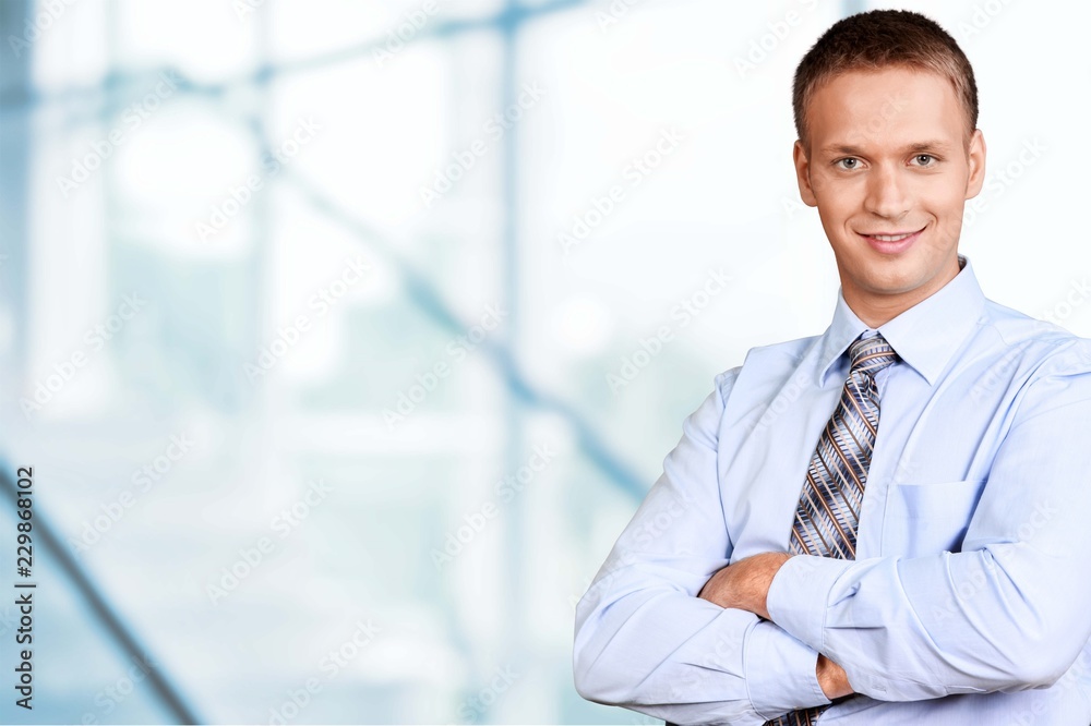 Smiling handsome businessman with crossed hands isolated Smiling handsome businessman with crossed hands isolated