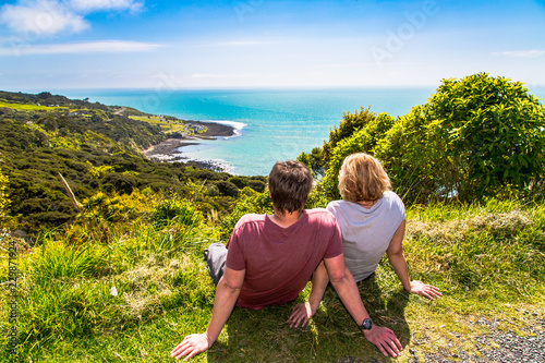 Couple overlooking Manu Bay, Raglan