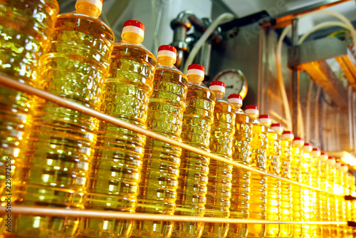 Sunflower oil. Line for the production and bottling of refined oil from sunflower seeds. Conveyor of food industry