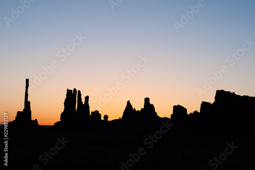 totem pole in monument valley at sunset