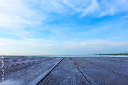 Old wooden board empty table top on beach background. Concept Summer, Beach, Sea, Relax. Can be used mock up for montage products display or design key visual layout.