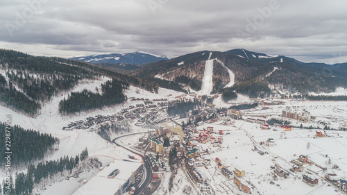Aerial view of the mountains. Carpathians. Bukovel. Village. Winter. Snow. Forest. Trees