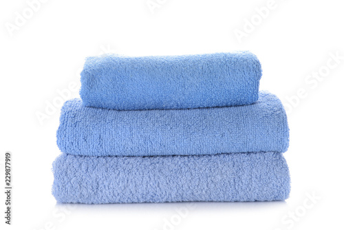 Stack of clean soft towels on white background