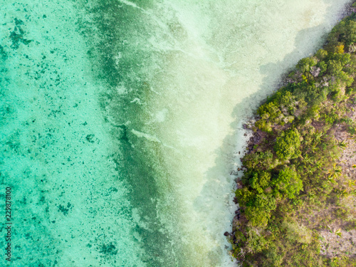 Aerial top down view tropical paradise pristine coast line rainforest at Bair Island. Indonesia Moluccas archipelago, Kei Islands, Banda Sea. Top travel destination, best diving snorkeling.