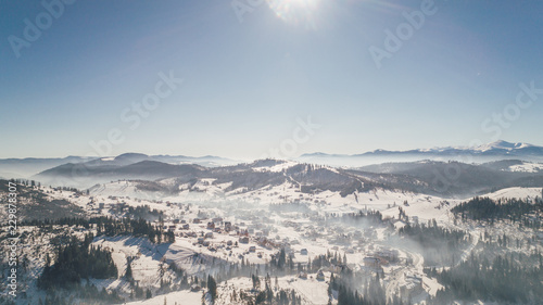 Aerial view of the mountains. Carpathians. Bukovel. Village. Winter. Snow. Forest. Trees