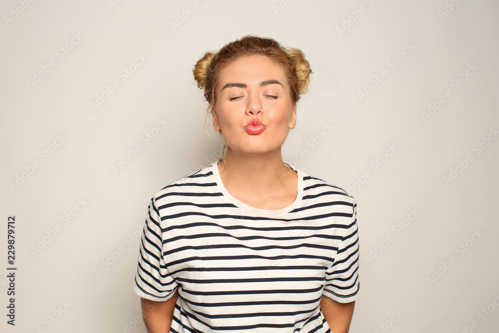 Portrait of beautiful young woman on light background Portrait of beautiful young woman on light background