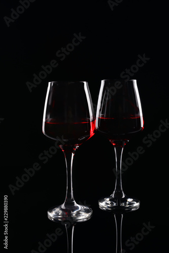 Glasses of red wine on dark background