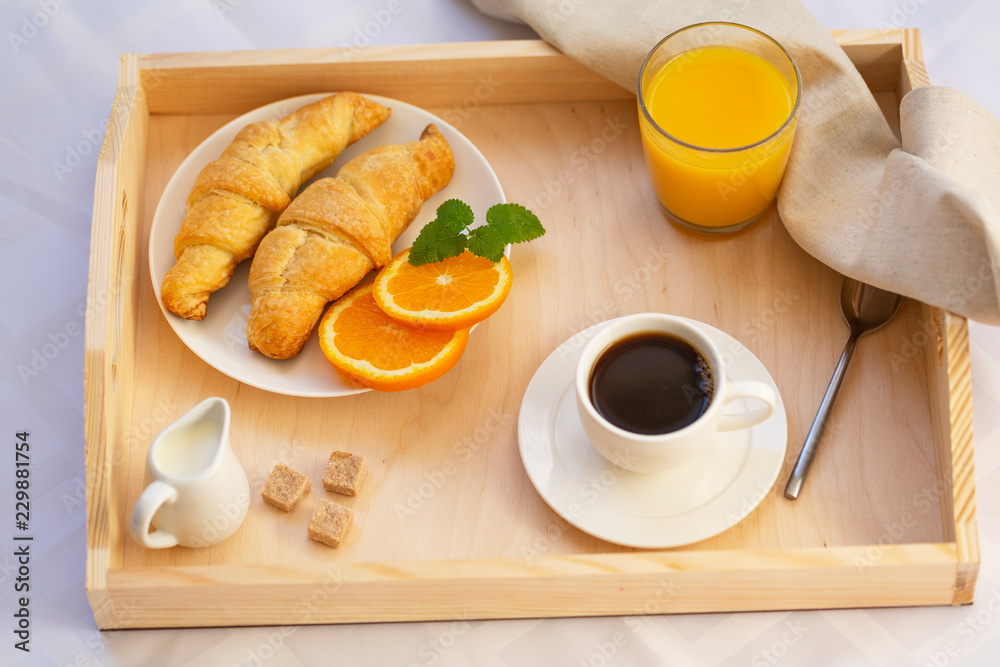 Breakfast in bed with coffee, croissants and juice Breakfast in bed with coffee, croissants and juice