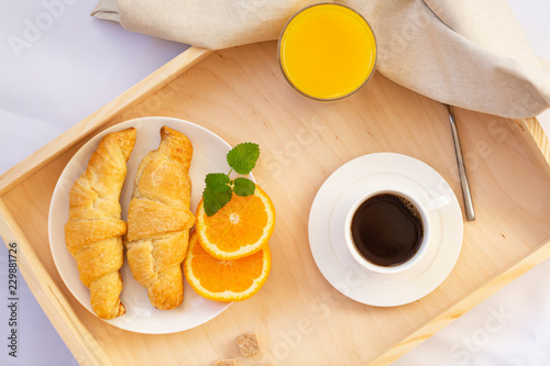 Breakfast in bed with coffee  croissants and juice