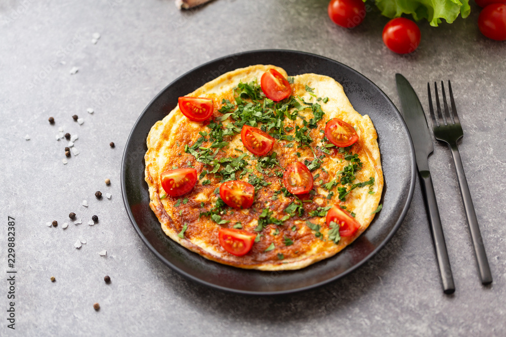Omelet with tomatoes and herbs. Delicious breakfast Omelet with tomatoes and herbs. Delicious breakfast