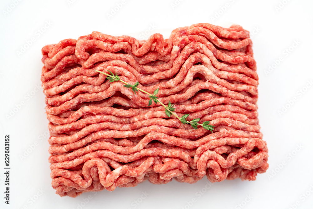 Beef and pork minced with fresh thyme isolated on white Beef and pork minced with fresh thyme isolated on white
