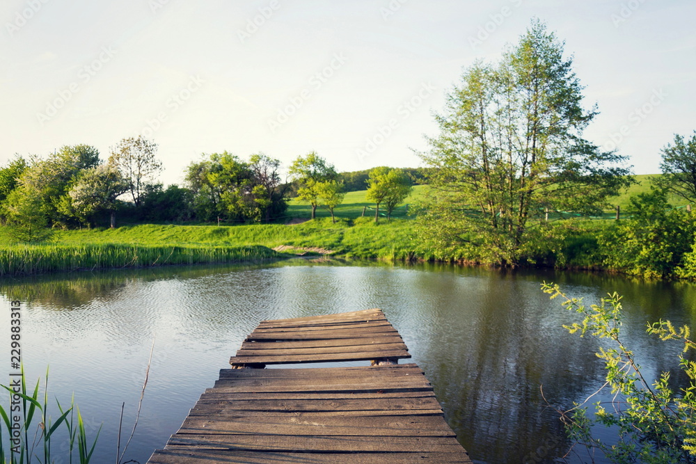 Pretty wooden pier at pond during sunset, colorful summer day, new life change concept, fresh start, new year resolution, dieting and healthy lifestyle Pretty wooden pier at pond during sunset, colorful summer day, new life change concept, fresh start, new year resolution, dieting and healthy lifestyle