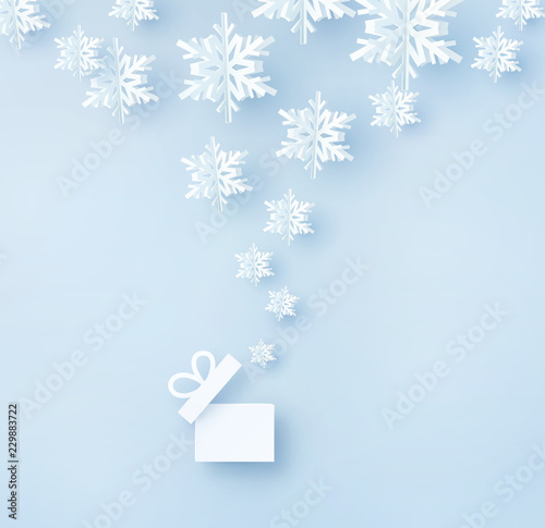 Christmas card with paper snow flakes. Open gift box and flying snowflakes on blue background. Vector xmas, New Year or winter concept.