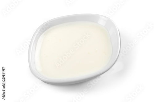 sour cream in bowl, isolated on white