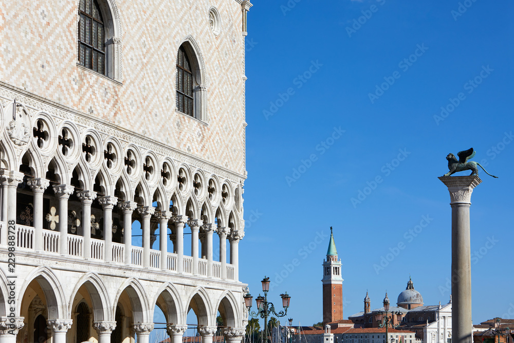 Venice, Doge palace and San Marco lion statue on column in a sunny day in Italy