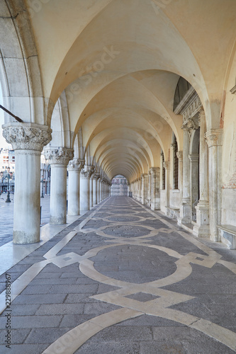 Ancient, white arcade in Venice, nobody in the early morning in Italy