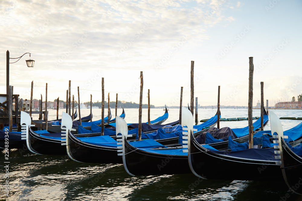 Gondola boats moored in Grand Canal in Venice, nobody in the early morning