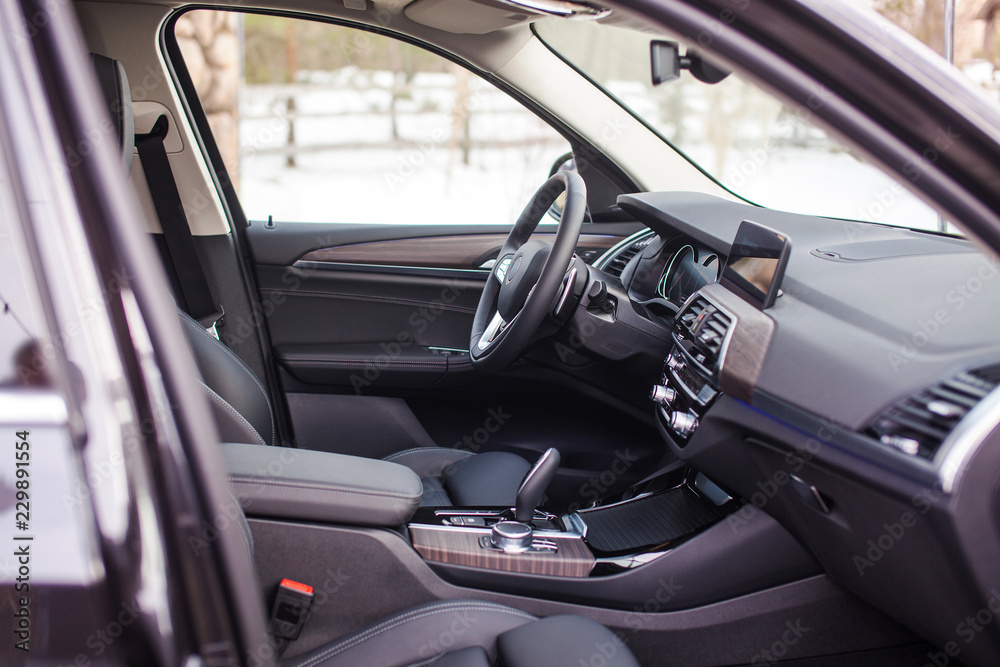 Interior of a modern passenger car with leather interior and wooden inserts