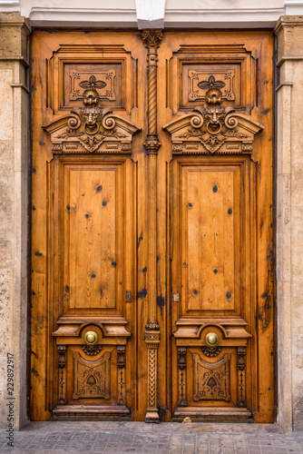 ornate wooden door with beautiful carvings in Valencia, Spain