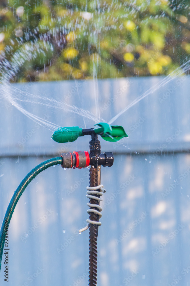 automatic watering system with water drops in the garden