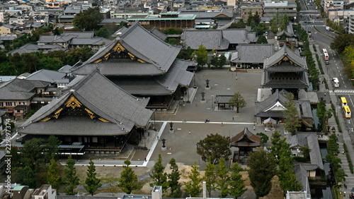 Aerial shots of the city of Kyoto. Skyscrapers and buildings expand out into the distance of the Japanese city as a stormy sky and clouds form over the cityscape.