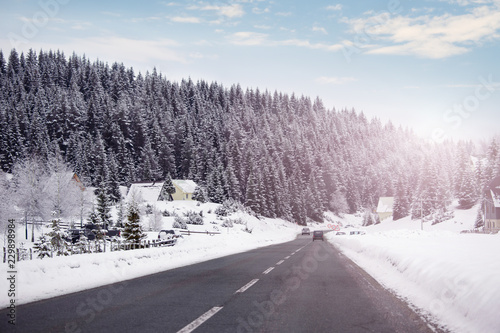 Car driving on a winter road in the mountains © scharfsinn86
