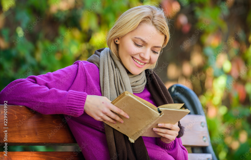 Girl sit bench relaxing with book fall nature background. Intellectual hobby. Lady bookworm read book outdoors fall day. Woman reading book. Fall literature top list. Book list for autumn season Girl sit bench relaxing with book fall nature background. Intellectual hobby. Lady bookworm read book outdoors fall day. Woman reading book. Fall literature top list. Book list for autumn season