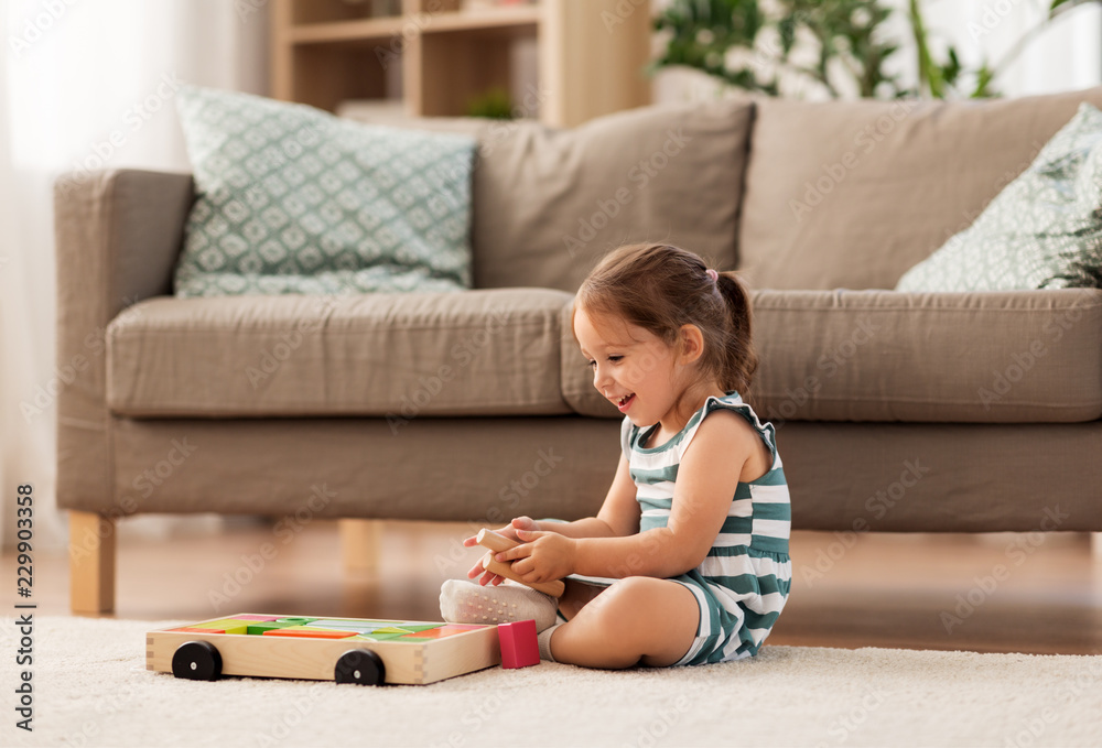 childhood and people concept - happy three years old baby girl playing with toy blocks at home childhood and people concept - happy three years old baby girl playing with toy blocks at home
