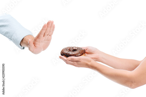 cropped image of man rejecting unhealthy chocolate doughnut isolated on white