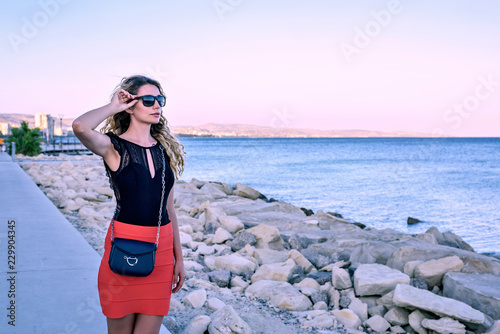 Woman enjoying the summer sunset portrait Limassol, Cyrpus. Sea view. Vintage...