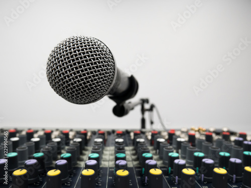 Silver microphone over mixer in studio