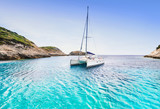 Beautiful bay with sailing boat catamaran, Corsica island, France