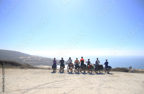 Team of bikers are looking at the Atlantic ocean in Portugal