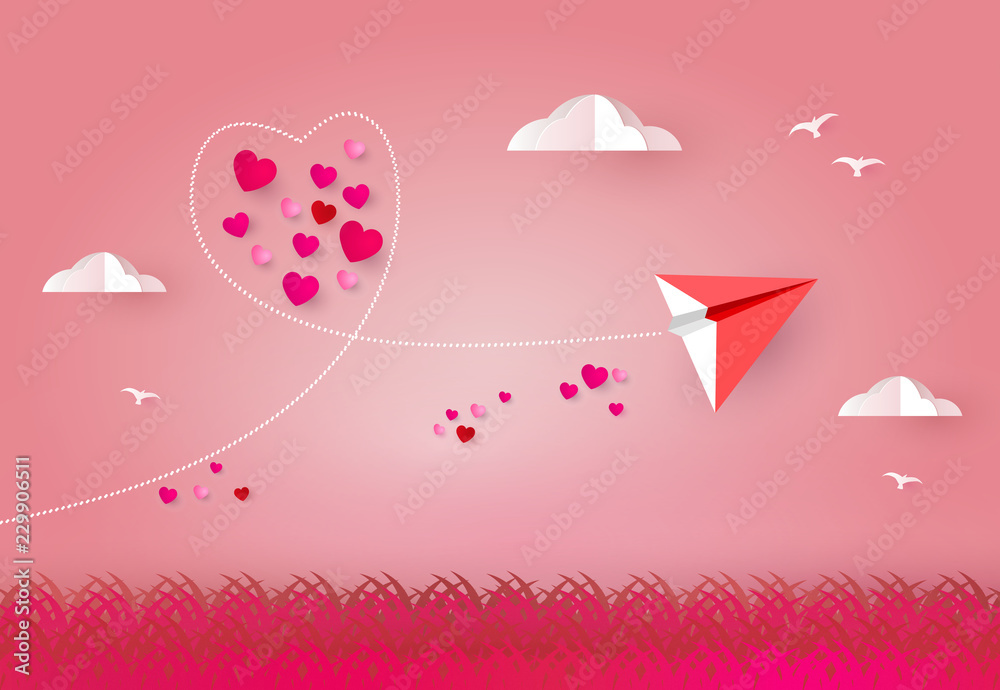 Love and valentines day.  Red paper airplane or rocket flying look like heart shape on sky and hearts