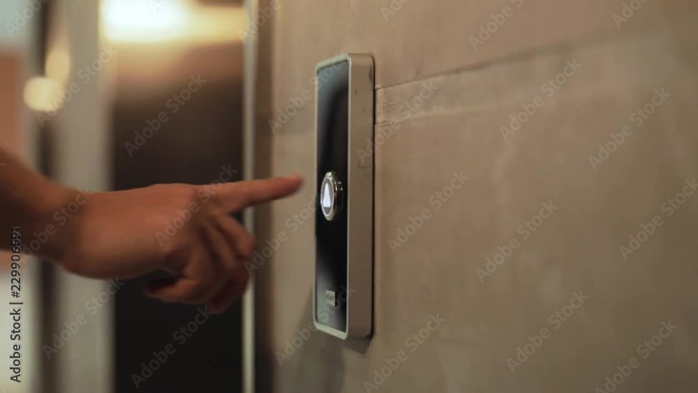 Close up hand young businessman a lot presses a button of lift to go up by a finger elevator business technology lift push building interior down choice control office open door