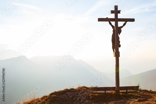 Billede på lærred Wooden crucifix with Jesus on a mountain hill
