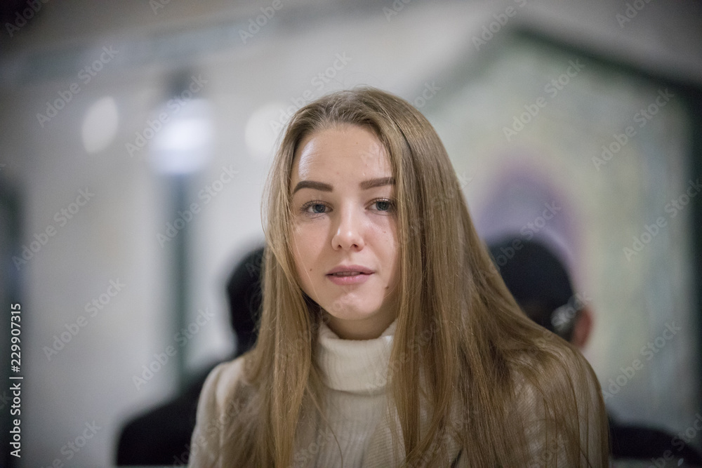 Obraz premium Portrait of beautiful young woman in the subway. Looking in the camera