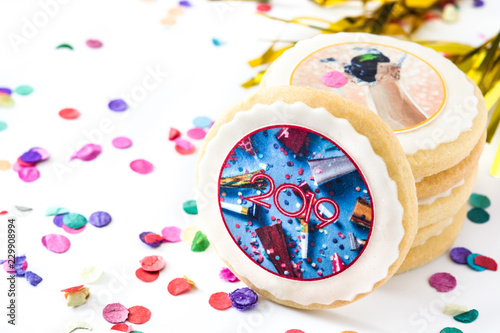 New Year cookies and confetti on white background. Copyspace