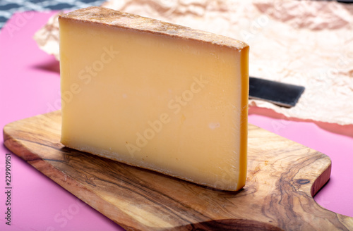Piece of aged Comte or Gruyere de Comte, AOC French cheese made from unpasteurized cow's milk in the Franche-Comte region of eastern France with traditional methods of production.